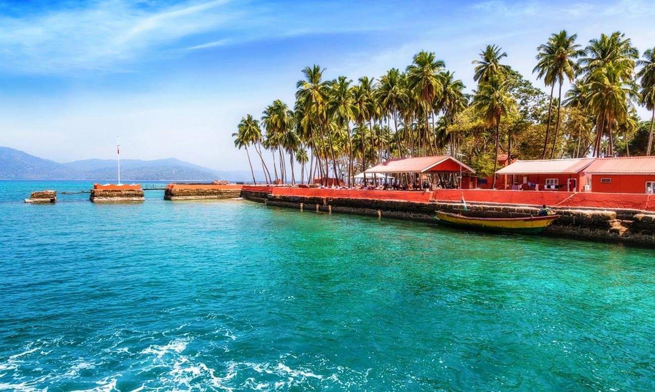 Ross Island shoreline with red coastal buildings and palm trees